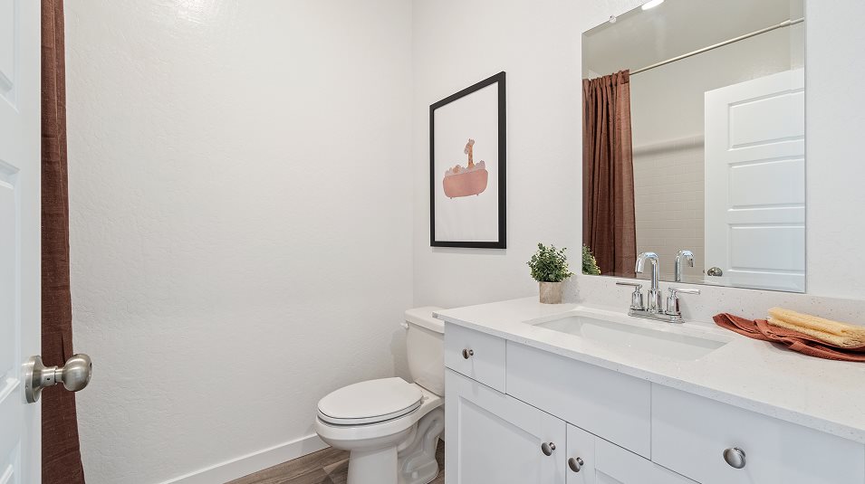 White quartz countertops with backsplash in the secondary bathroom
