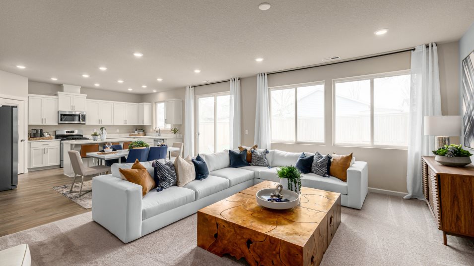 Furnished great room with the kitchen and dining space in the background