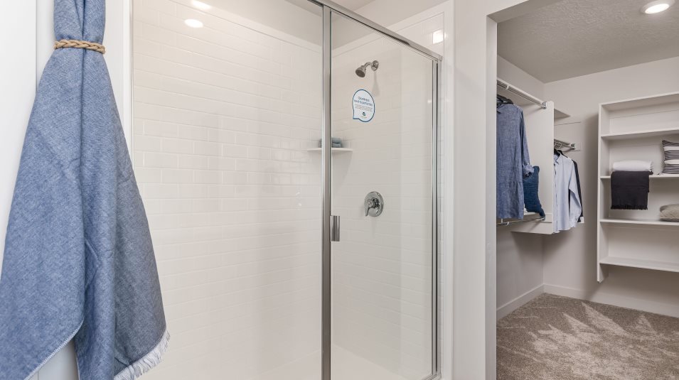 owner’s suite glass-enclosed shower includes designer plumbing fixtures 