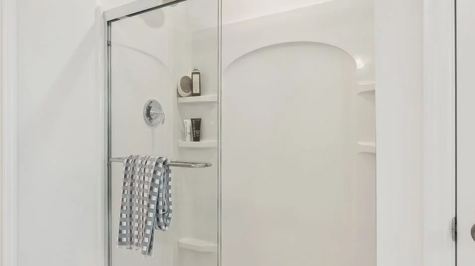 Owners Suite bathroom Glass-enclosed shower with chrome fixtures