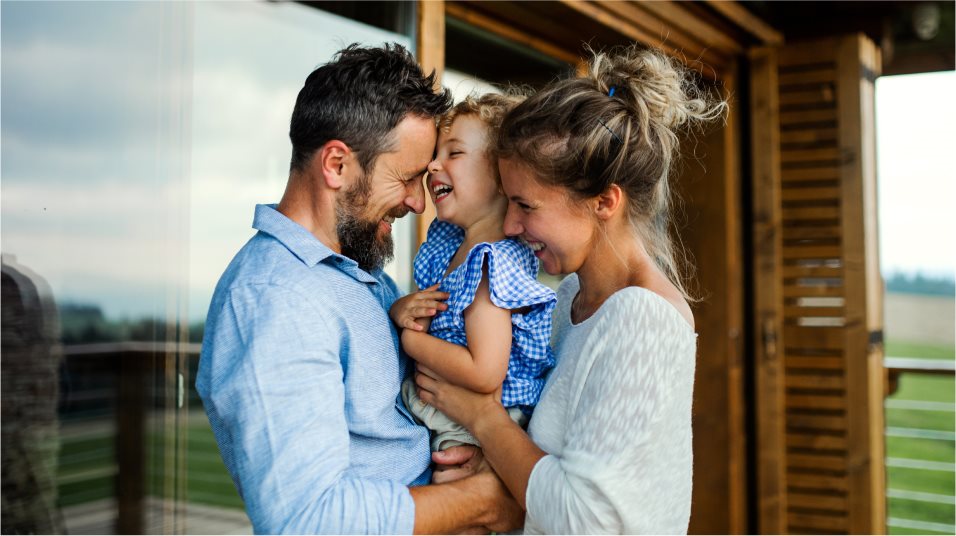 Family in front of log cabin