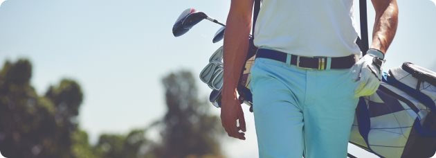 Golf man walking with bag of clubs
