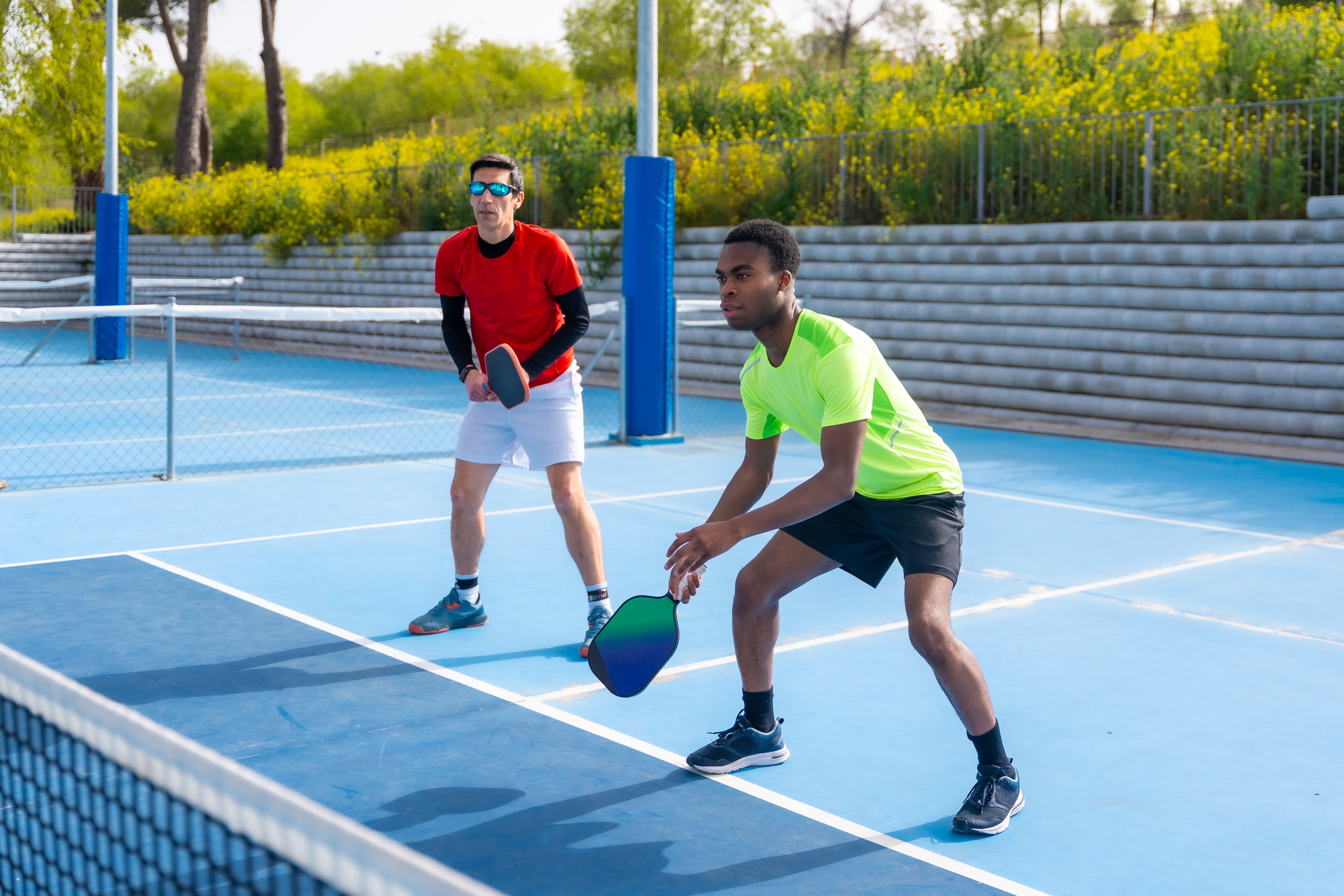 Two men play pickleball