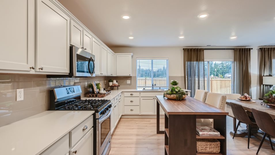 Kitchen island and countertops with dining space visible