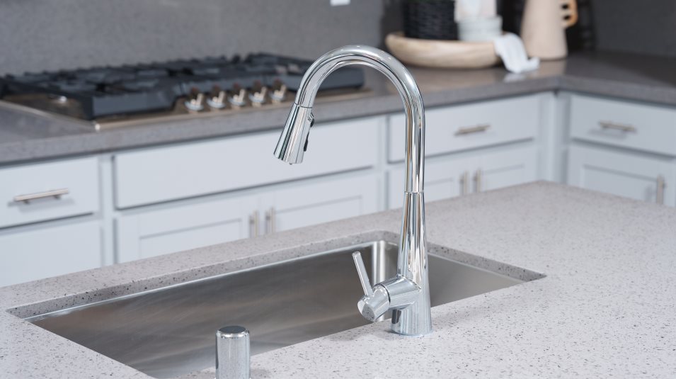 Kitchen sink with pull-down faucet feature