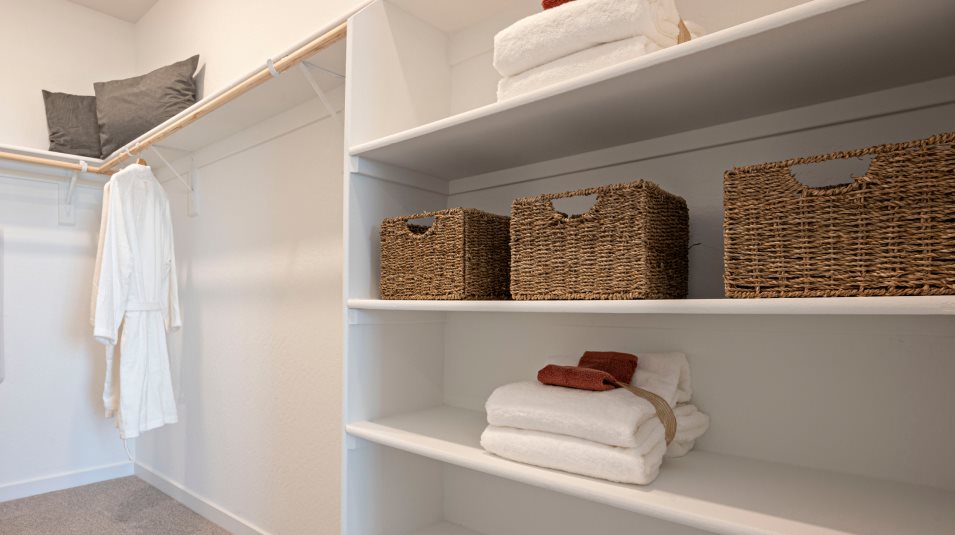 Walk-in closet with wood shelving and railing