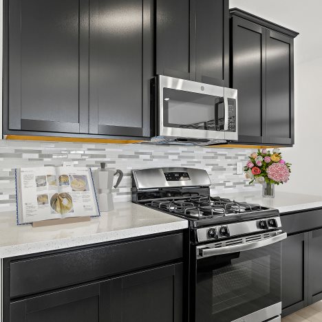 Kitchen with stainless steel range and microwave above range