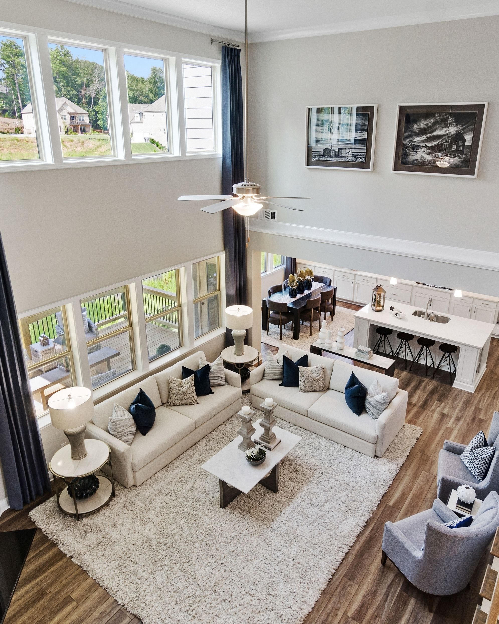 Overhead shot of the living room with a wall of windows and comfortable L-shaped couch.