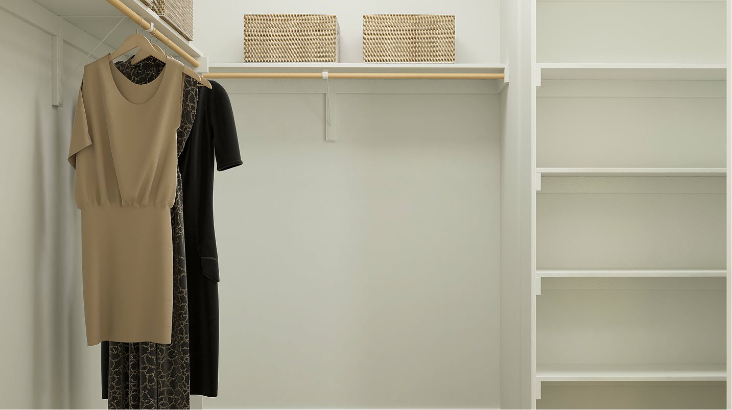 Walk-in closet with wood shelving and railing in the owner’s suite