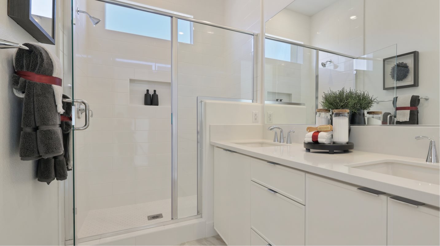 Semi-frameless shower enclosure with full-height ceramic tile surround and tile floor