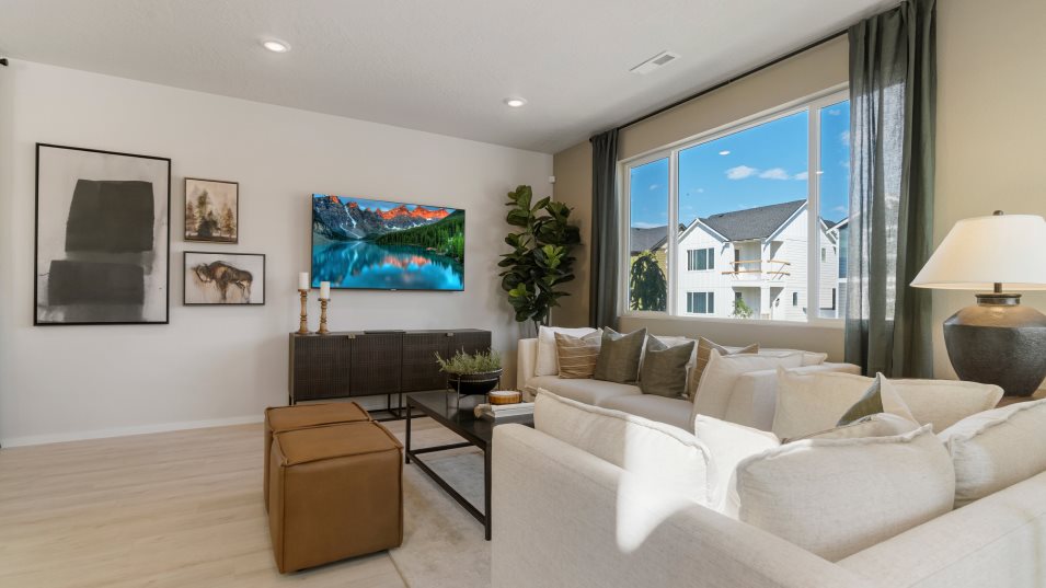 Furnished great room with large window visible