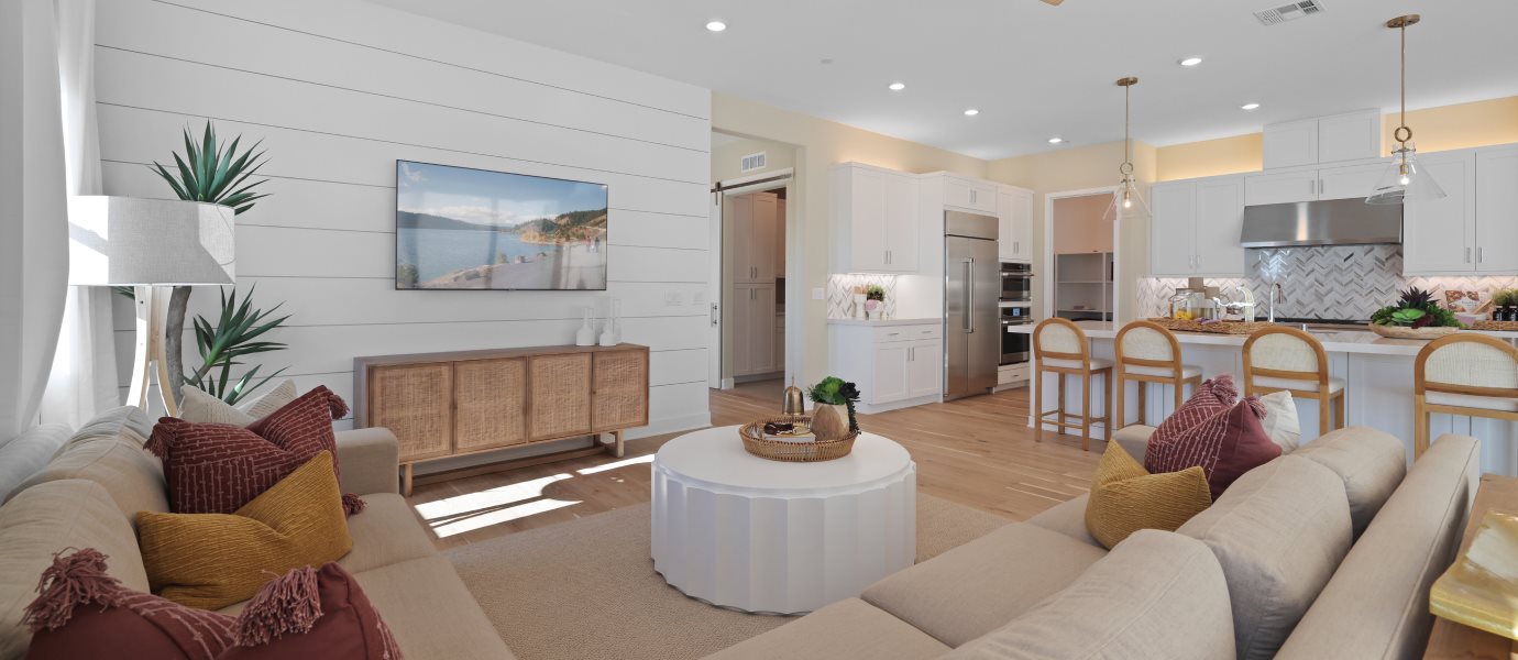 Furnished great room image with kitchen in the background