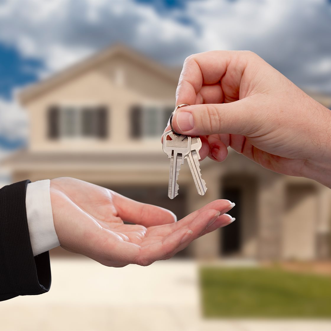 IMAGE: Handing keys over in front of house