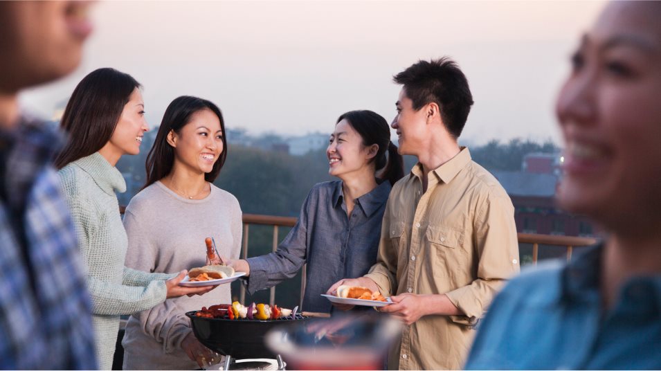 Group of people talking at a barbecue