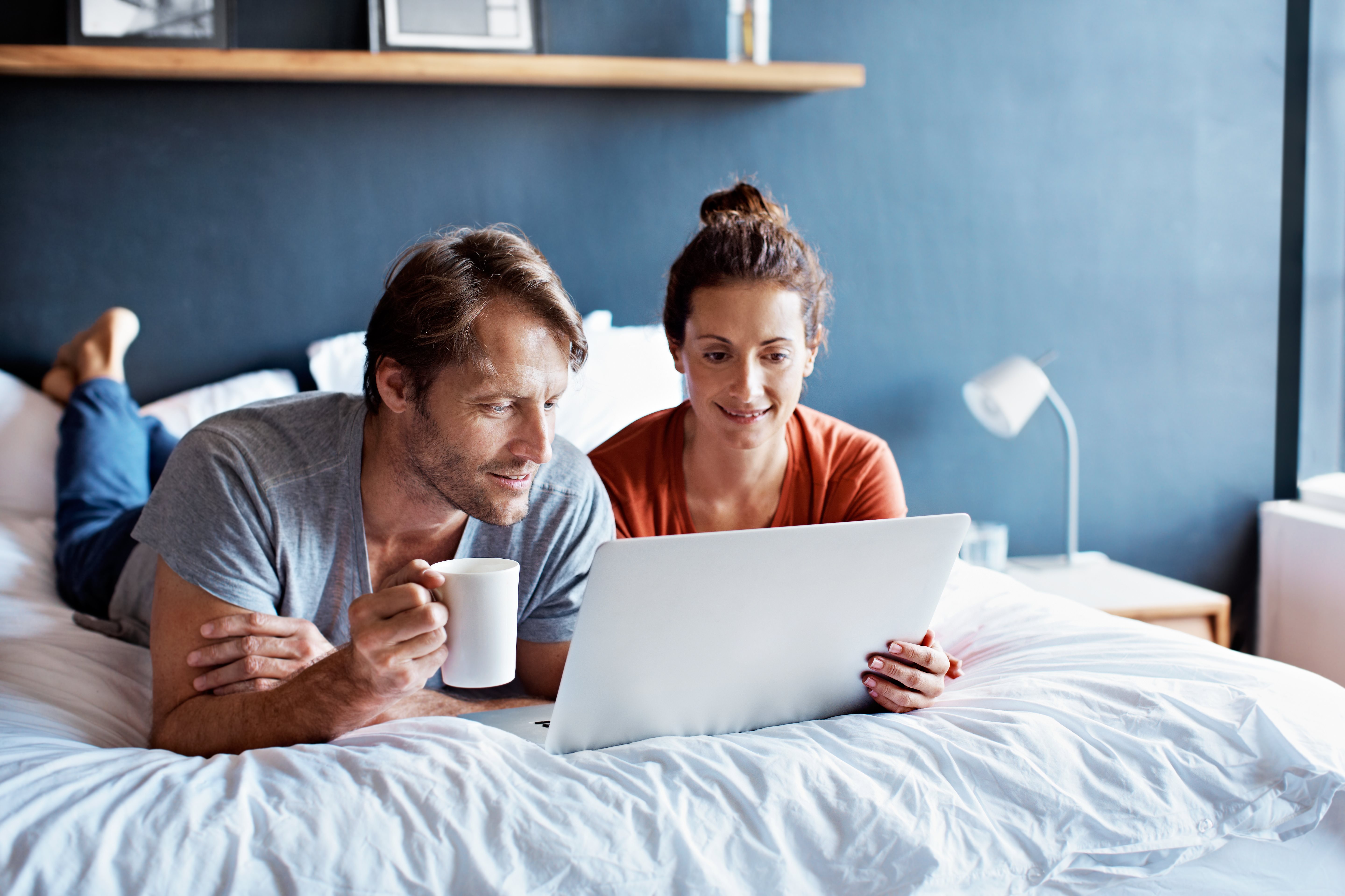 Couple In Bed Laptop