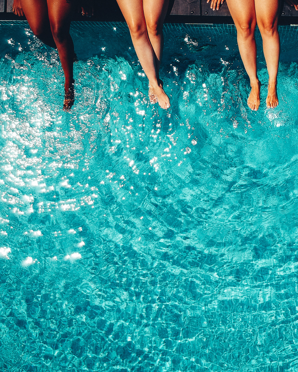 Women relaxing poolside